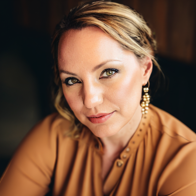 women in copper looking at camera